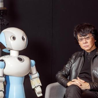 Roboticist and engineer Hiroshi Ishiguro with Robovie, one of his creations.