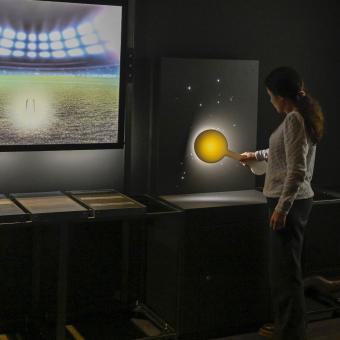 A visitor interacts with an exoplanet detection module.
