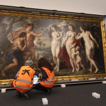 Restorers from the Prado Museum inspect the condition of "The Judgment of Paris" at CaixaForum Barcelona.