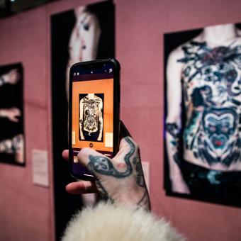 The show features more than 240 pieces from all over the world, including paintings, drawings, books, inked silicone, tattooing tools, masks, photographs, stamps and 9 audiovisuals.