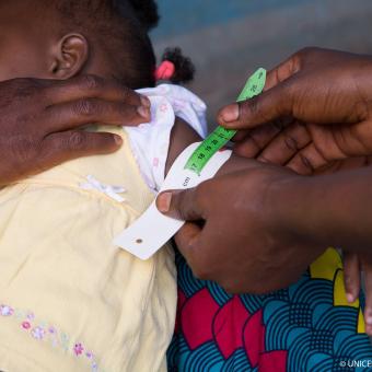 Baby being examined in Mado Doré, Guinea. © UNICEFUNI213147 Mazboudi.