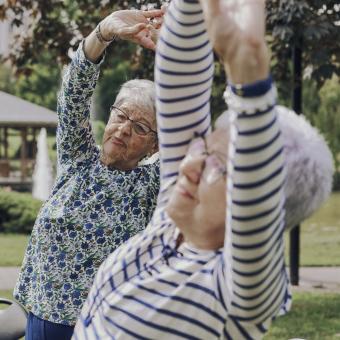 Two women taking gymnastics classes.