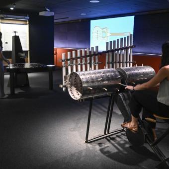 A visitor uses the composing machine to create their own melody. 