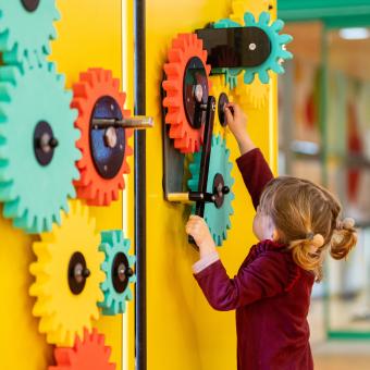 A girl plays in one of the modules of the renovated Clik