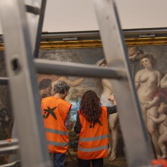 Restorers from the Prado Museum inspect the condition of "The Judgment of Paris" at CaixaForum Barcelona.