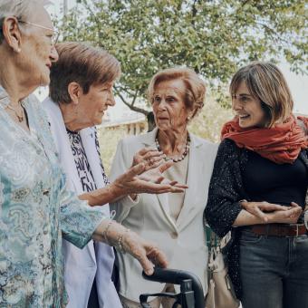 Dones grans passejant i xerrant amb algú més jove.