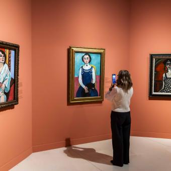 Una mujer fotografía la obra «Marguerite au chat noir», de Henri Matisse, en CaixaForum Madrid.