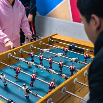 Two children playing table football in the CaixaProinfancia 3-6 Growth Spaces at the Barró Association.