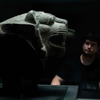 A visitor admires one of the pieces on display at the "Ashurbanipal" exhibition at CaixaForum Madrid.