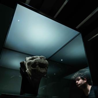 A visitor admires one of the pieces on display at the "Ashurbanipal" exhibition at CaixaForum Madrid.
