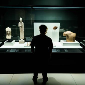 A man observes the various works in one of the rooms of the "Asurbanipal" exhibition at CaixaForum Madrid.