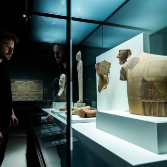 A visitor admires one of the pieces on display at the "Ashurbanipal" exhibition at CaixaForum Madrid