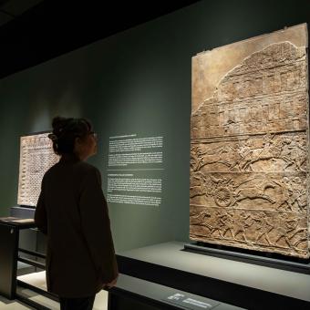 A woman observes one of the pieces on display at the "Ashurbanipal" exhibition at CaixaForum Madrid.