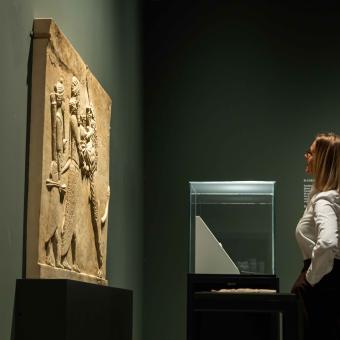 A woman observes one of the pieces exhibited in the "Ashurbanipal" exhibition at CaixaForum Madrid.