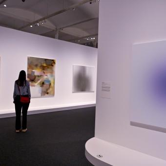 Una dona recorrent les sales de l'exposició Desenfocat. Una altra visió de l'art a CaixaForum Barcelona.