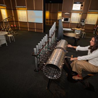 Una visitant pujada a la Composing Machine de l'exposició. 