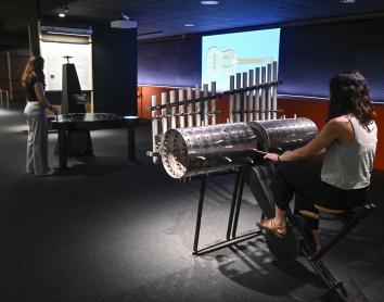 A visitor uses the composing machine to create their own melody. 