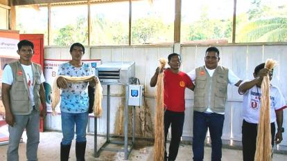 Workers showing the dried strands.