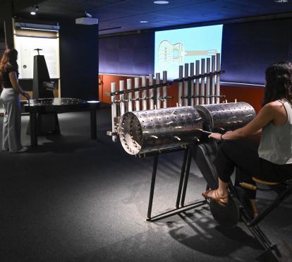 A visitor uses the composing machine to create their own melody. 