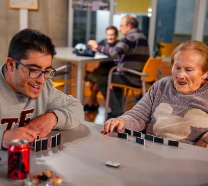 Luisa y Adrián jugando al dominó. 