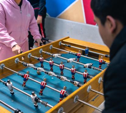 Two children playing table football in the CaixaProinfancia 3-6 Growth Spaces at the Barró Association.