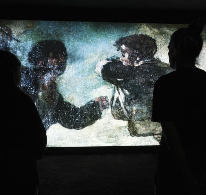 Dos personas observan una de las obras de Philippe Parreno, presente en la exposición Fuera de marco en CaixaForum Sevilla. 