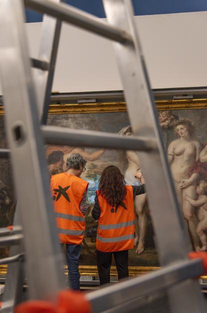 Restorers from the Prado Museum inspect the condition of "The Judgment of Paris" at CaixaForum Barcelona.