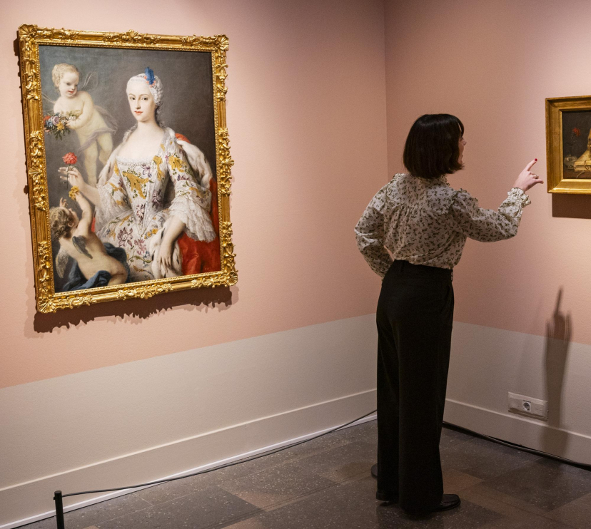 Una mujer admirando las obras presentes en la exposición «La botánica en el arte» en CaixaForum Girona.